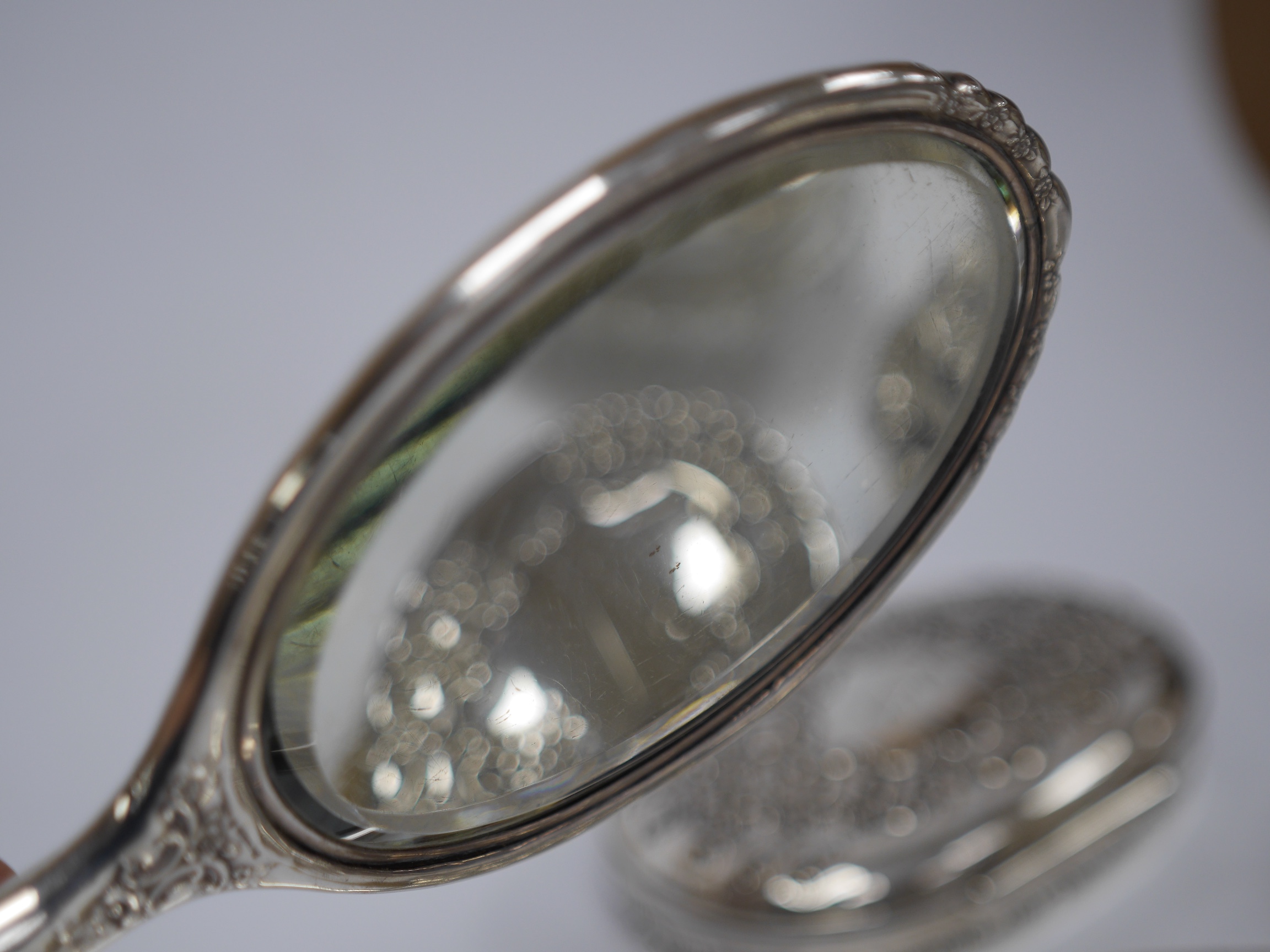 A late 19th/early 20th century Tiffany & Co sterling silver and silver mounted toilet set, comprising a hand mirror, two brushes, a shoe horn, powder jar and compartmental box with engraved inscription, 14cm, all engrave